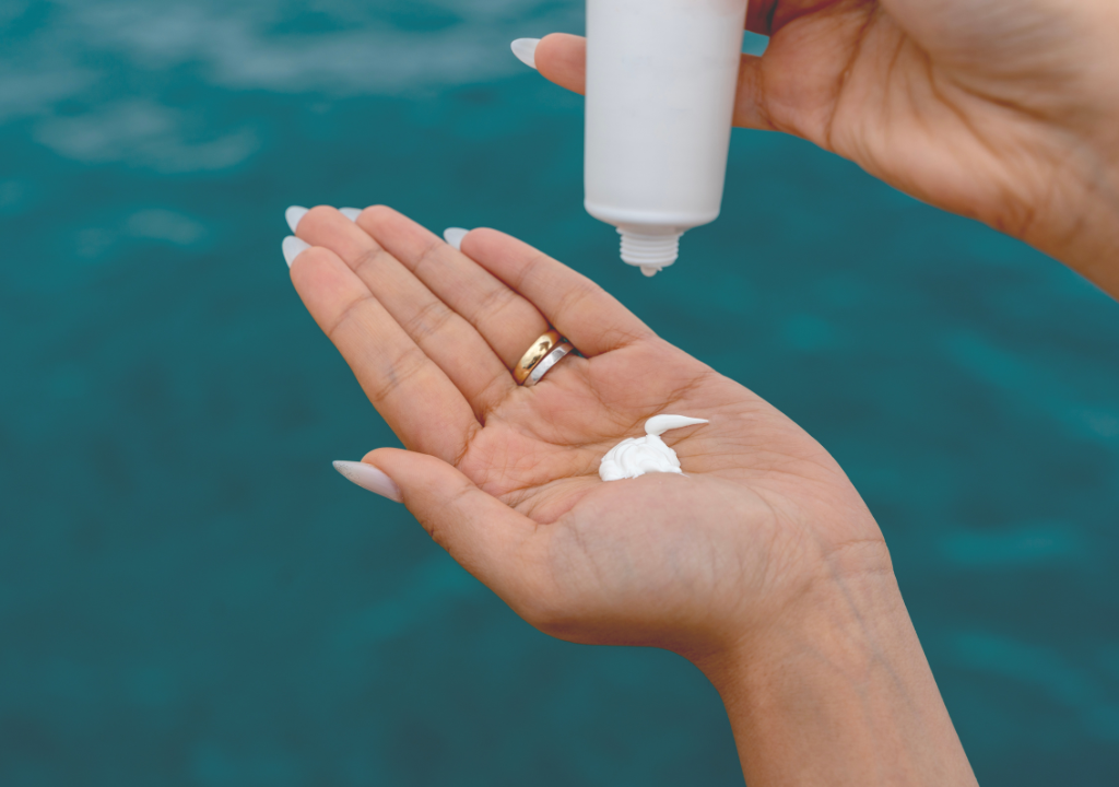 person putting spf into their hand