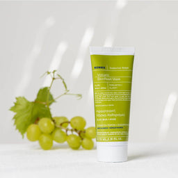 KORRES Santorini Grape Clear Skin Volcanic Mask tube with a bunch of grapes behind it