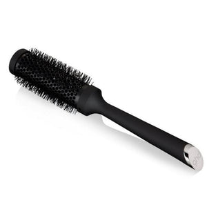 Black hairbrush with silver ferrule on a white background