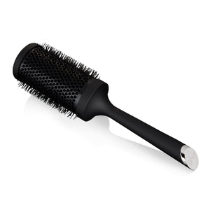 Black round hairbrush on a white background