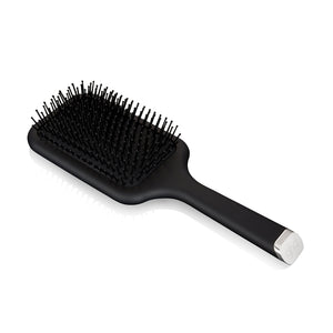 Black paddle hairbrush on a white background