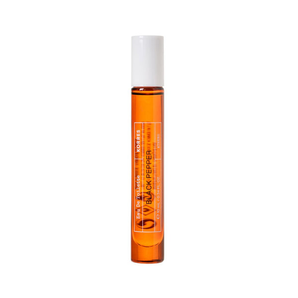A small cylindrical glass roller bottle filled with amber-orange liquid, featuring a white cap and a white label with orange text that reads 'VOCATES' and 'BLACK PEPPER'.
