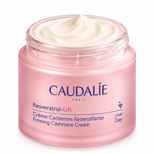 Caudalie Resveratrol-Lift Firming Cashmere Cream in a pink jar with an open lid showing the cream inside, on a white background.
