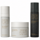 Three skincare products from Irene Forte are arranged against a plain white background: a tall white bottle on the left, a short white jar in the center, and a tall black bottle on the right. Each container has gold lettering and is photographed cleanly with soft shadows.