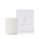 White candle with ribbed texture next to its packaging box on a white background
