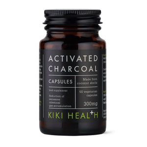 Bottle of Kiki Health activated charcoal capsules on a white background
