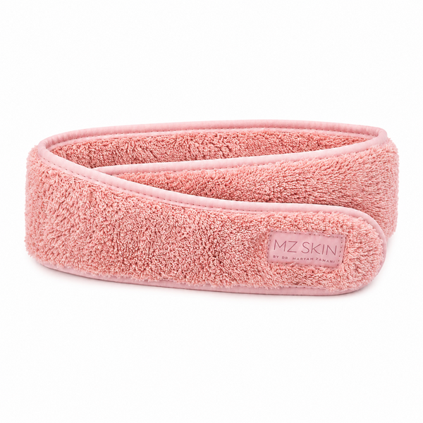 A pink textured terry cloth hair wrap headband with a small rectangular brand label reading 'MZ SKIN' on a clean white background.