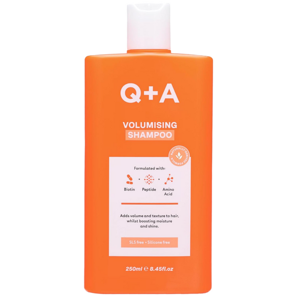 Orange shampoo bottle with 'Q+A' branding on a white background