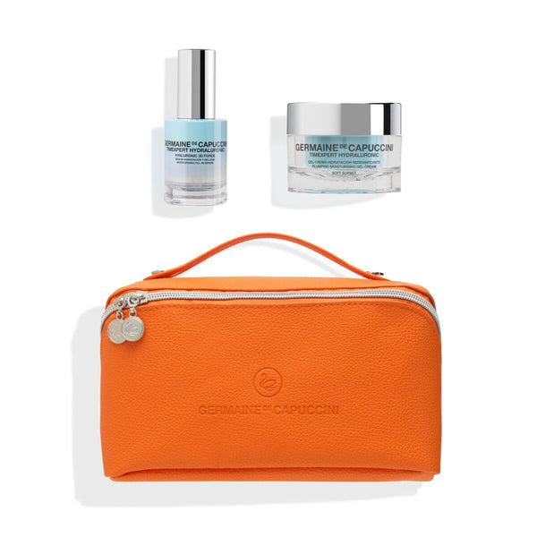 Orange travel pouch with two skincare products on a white background
