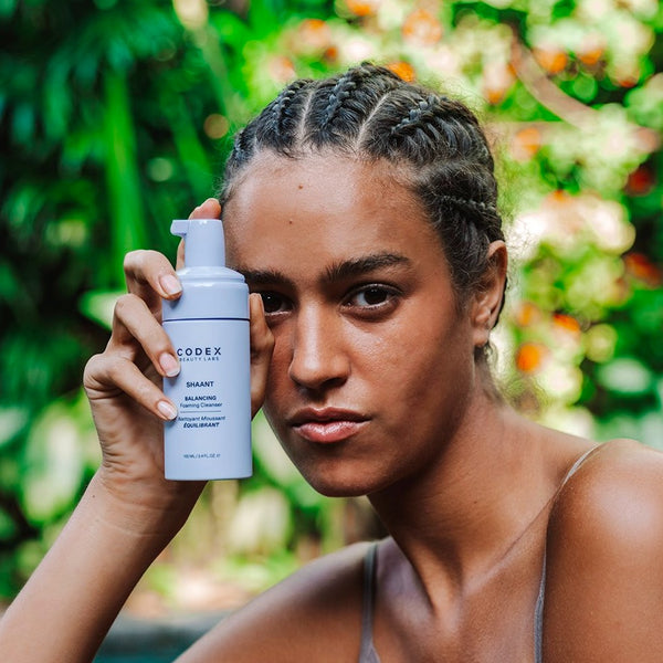 Model holding Codex Labs Shaant Balancing Cleanser