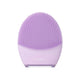 A lavender purple FOREO facial cleansing device with a textured silicone brush head, centered on a clean off-white background.