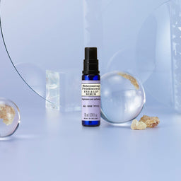 Neal's Yard Remedies Rejuvenating Frankincense Eye & Lip Serum in front of a clear orb