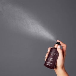 Grow Gorgeous Intense Thickening Spray being sprayed in to the air