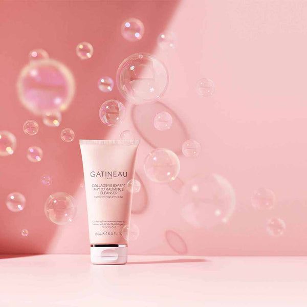 A tube of Gatineau Collagene Expert Phyto Radiance Cleanser with bubbles blown around it