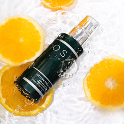 OSKIA CityLife Facial Mist placed in water with slices of oranges