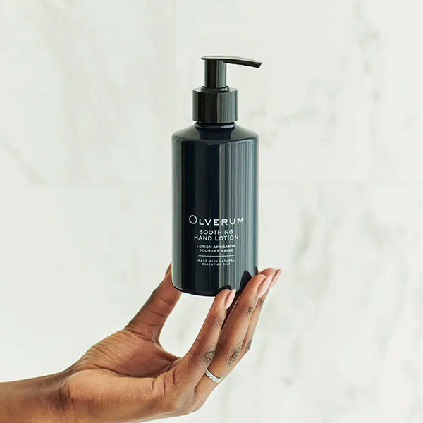 Olverum Soothing Hand Lotion held in the fingertips of a hand