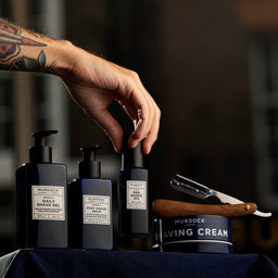 a range of murdock london shaving products on a wooden bench
