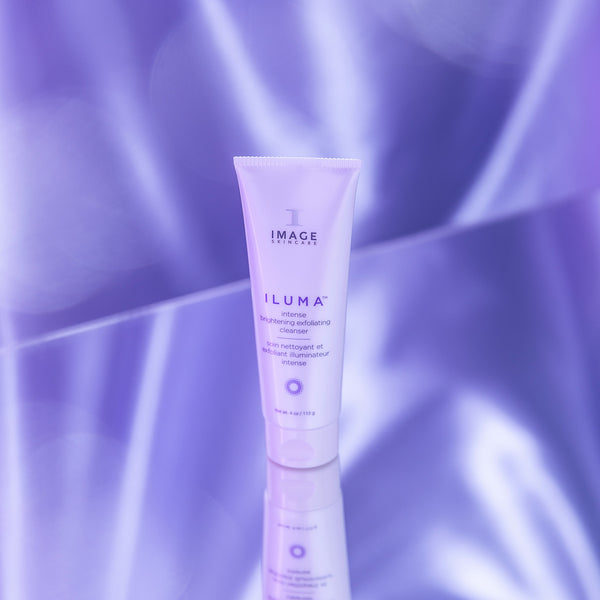 Image Skincare Iluma Brightening Exfoliating Cleanser tube on a florescent purple background
