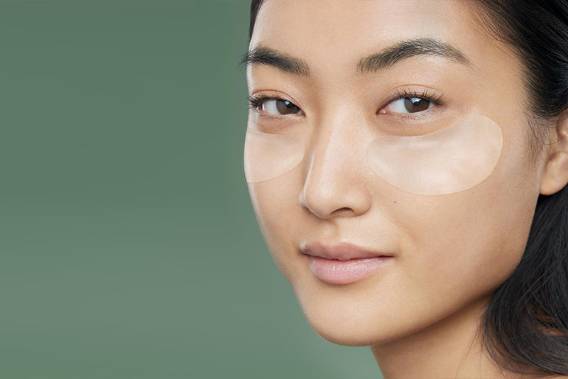 Woman's face with eye gel patches under eyes