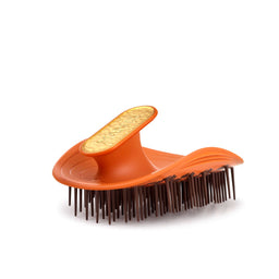 Orange pet grooming brush with brown bristles on a white background