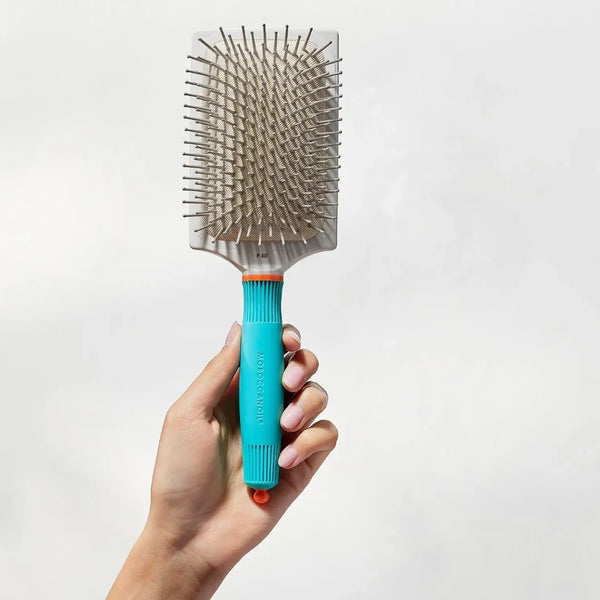 Moroccanoil Paddle Brush P80 being held to the air