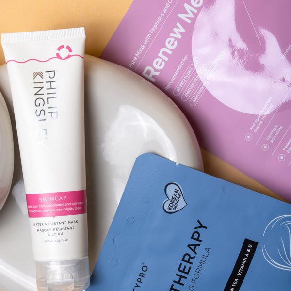 Skincare products including a tube and packets on a beige background