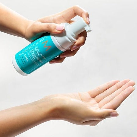 Moroccanoil Curl Control Mousse being poured into a hand
