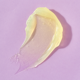 Yellow cream smear on a pink background