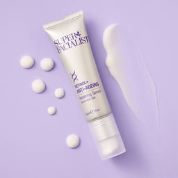 a tube of Super Facialist Retinol+ Anti-Ageing Serum on a purple background with a smear of texture 