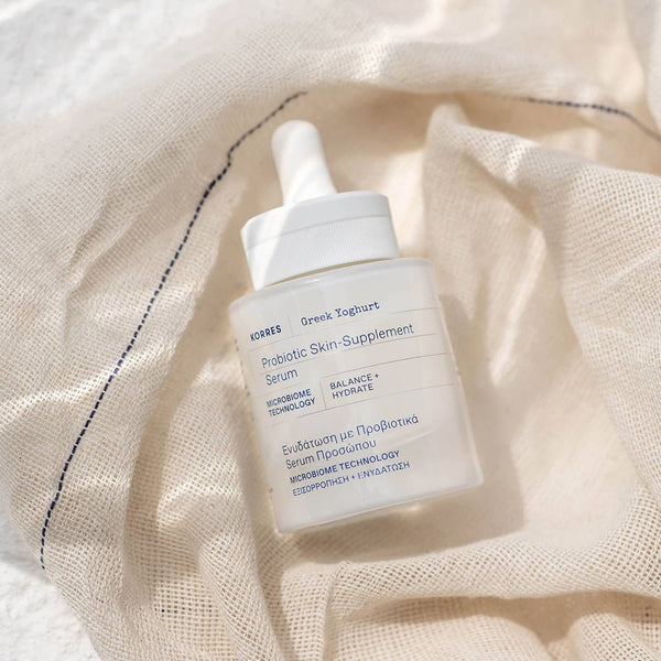 KORRES Greek Yoghurt Probiotic Skin-Supplement Serum laying on a canvas bag 