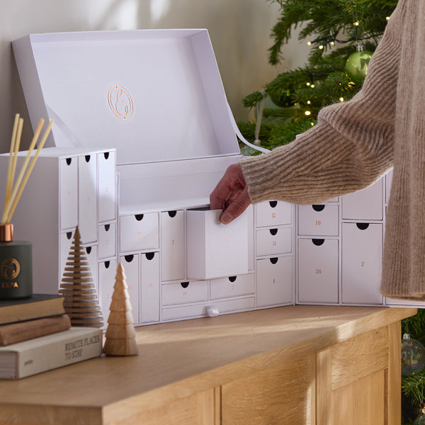 a person opening a day from the ESPA Wellness Advent Calendar