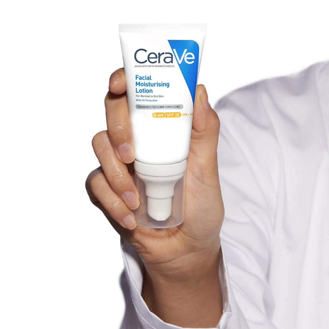 Model holding CeraVe Facial Moisturising Lotion SPF 30
