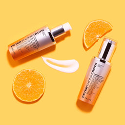 two bottles of Peter Thomas Roth Potent-C Power Serum with two slices of orange