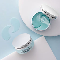 a birds eye view of two Peter Thomas Roth Water Drench Hyaluronic Cloud Hydra-Gel Eye Patches tubs with one lid removed