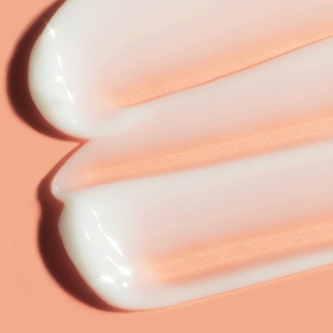 Close-up of white cream on a peach-colored background