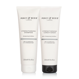 Two Percy & Reed hair care products on a white background