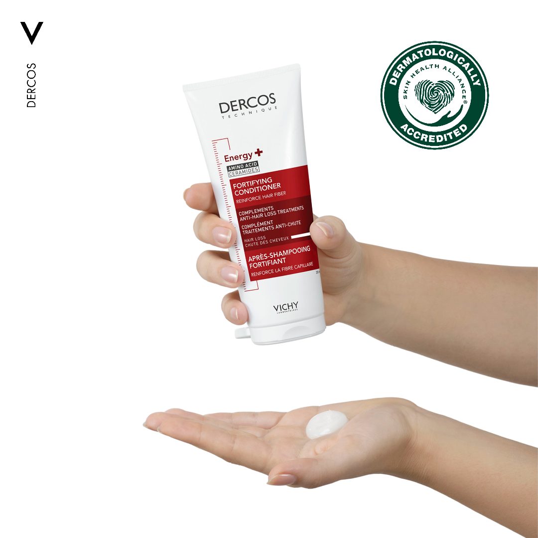 A user applying the conditioner to their hand