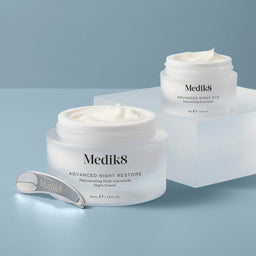 Medik8 Advanced Night Restore tub with an open lid showing its contents 