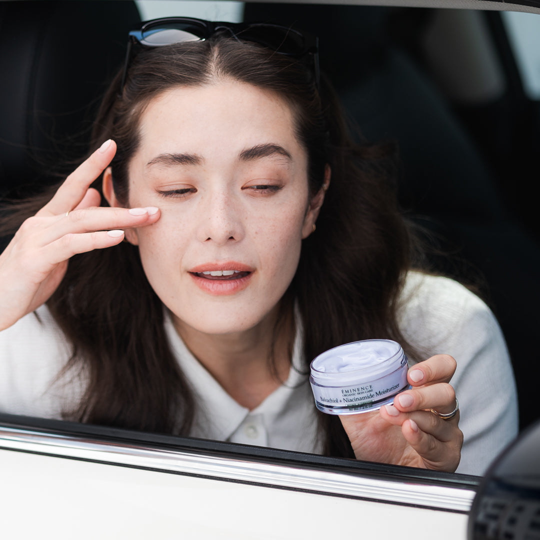 model applying Eminence Organic Skin Care Bakuchiol + Niacinamide Moisturizer