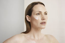 a women with cleanse applied to her cheek