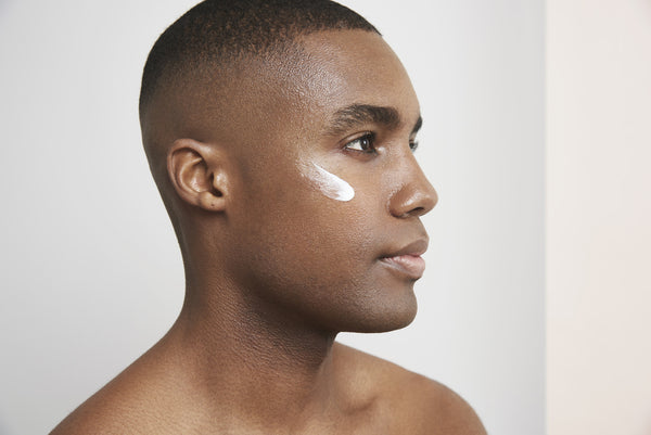 a man with the cream applied to his cheek