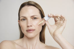 a women applying the tincture to her face
