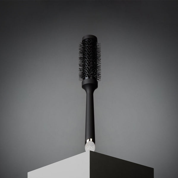 Black hairbrush on a gray background