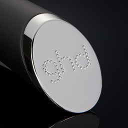 Close-up of a black and silver cylindrical object with 'GIVI' branding on a black background
