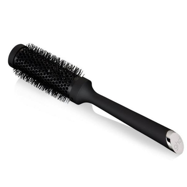 Black hairbrush with silver ferrule on a white background