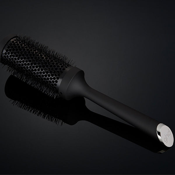 Black hairbrush on a black background