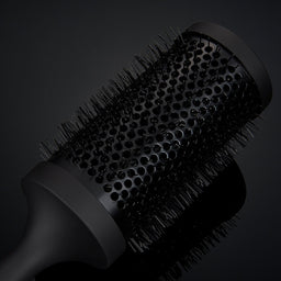 Black hairbrush on a black background
