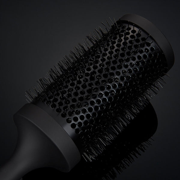 Black hairbrush on a black background