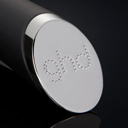 Close-up of a black and silver cylindrical object with 'GIVI' branding on a black background