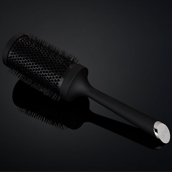 Black hairbrush on a dark background